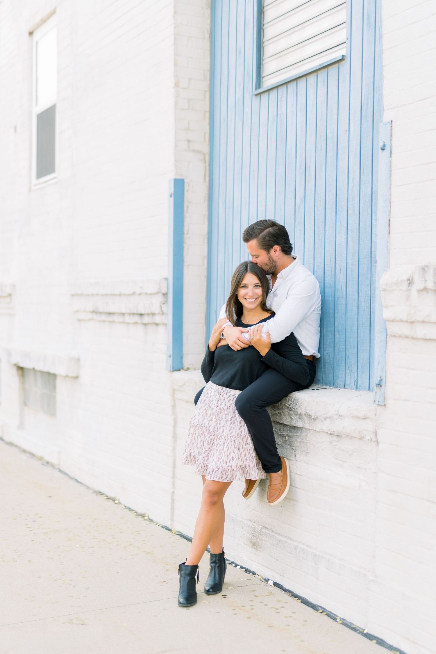 Des Moines Engagement photos in downtown Des Moines, Iowa with light and airy photographer Nicole Laing