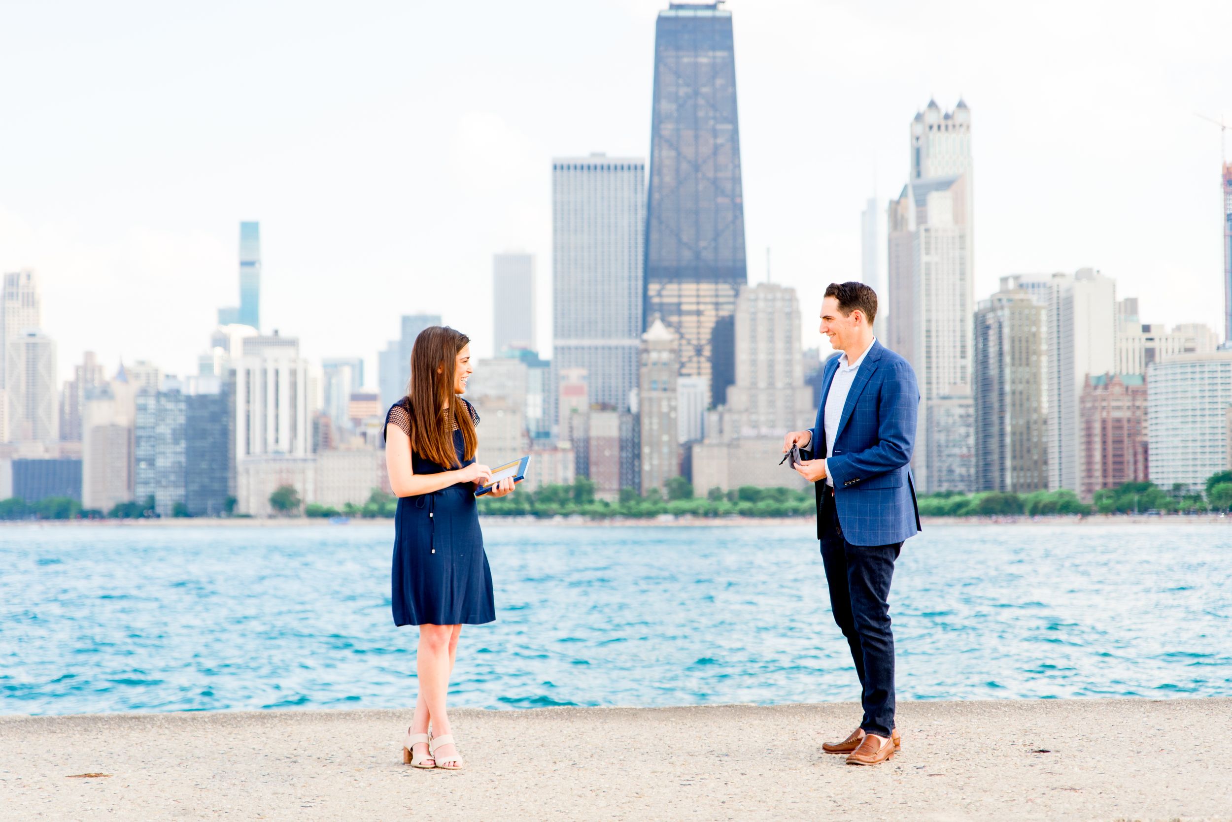 woman reading note from man before he proposes at North Avenue Beach