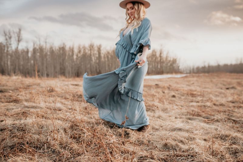 Blue flowy dress during Alberta maternity photoshoot