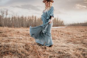 Blue flowy dress during Alberta maternity photoshoot