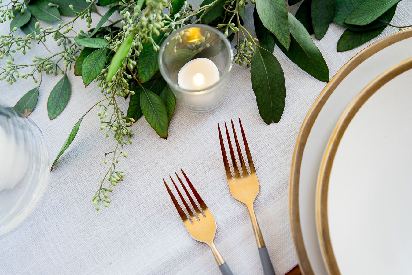 gold forks and plates set with eucalyptus at Pennyroyal Farm outdoor wedding
