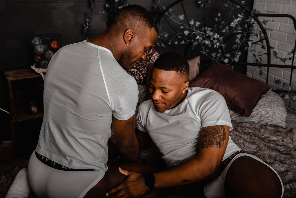 An intimate family moment captured in a cozy bedroom setting.