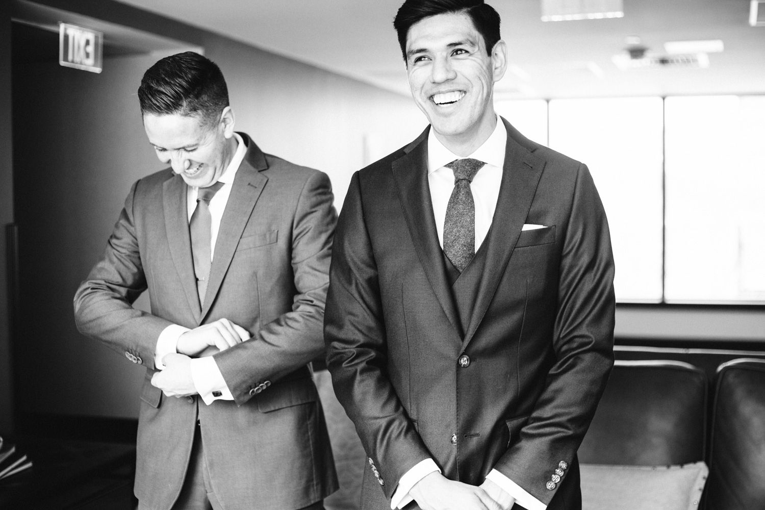 Groom and groomsman share a laugh before a Hudson Valley winter wedding