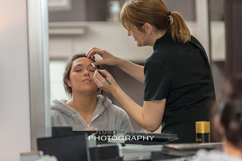bride having eyebrow make up applied