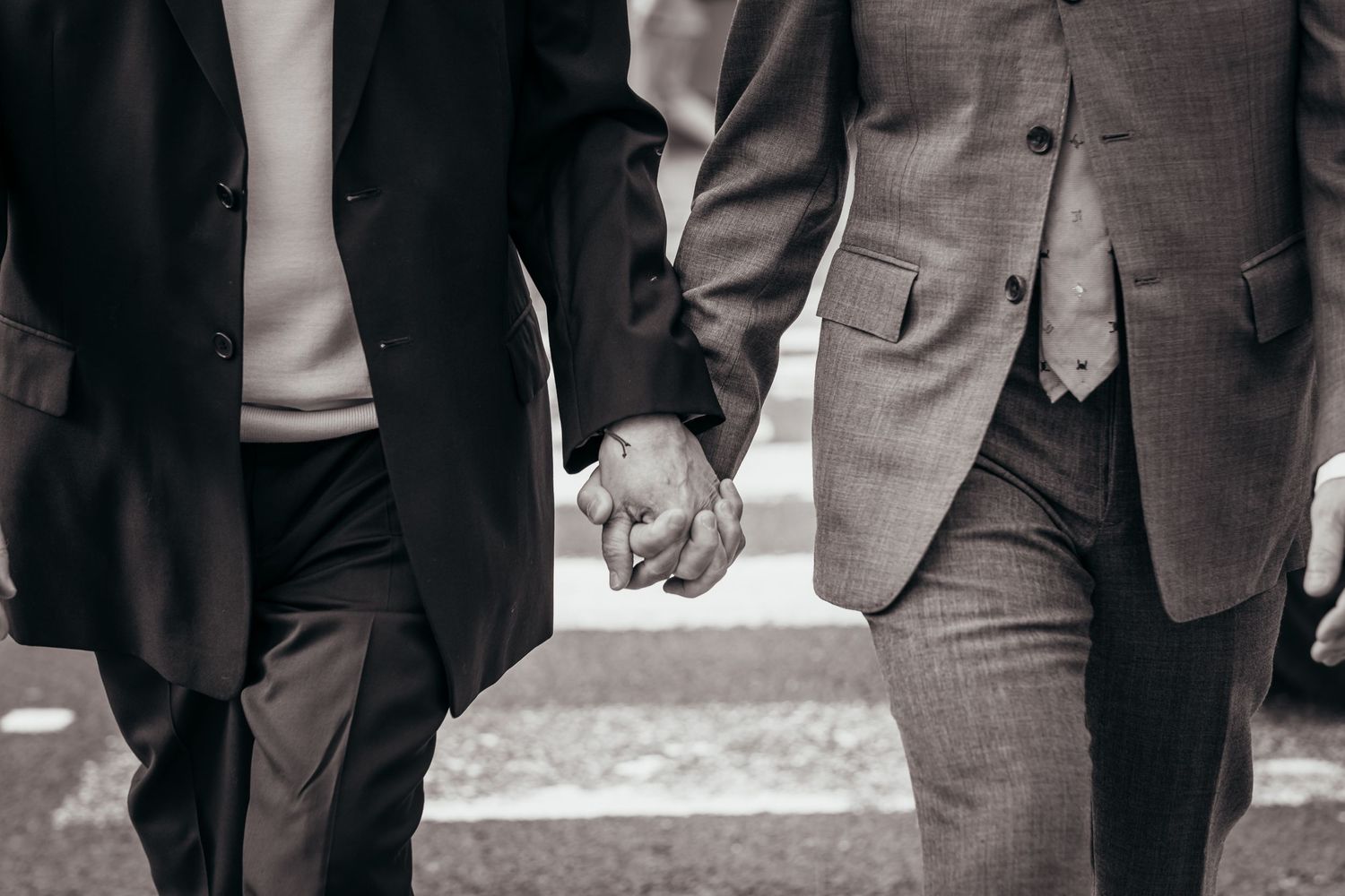 A gay couple walk hand in hand on their wedding day in London.