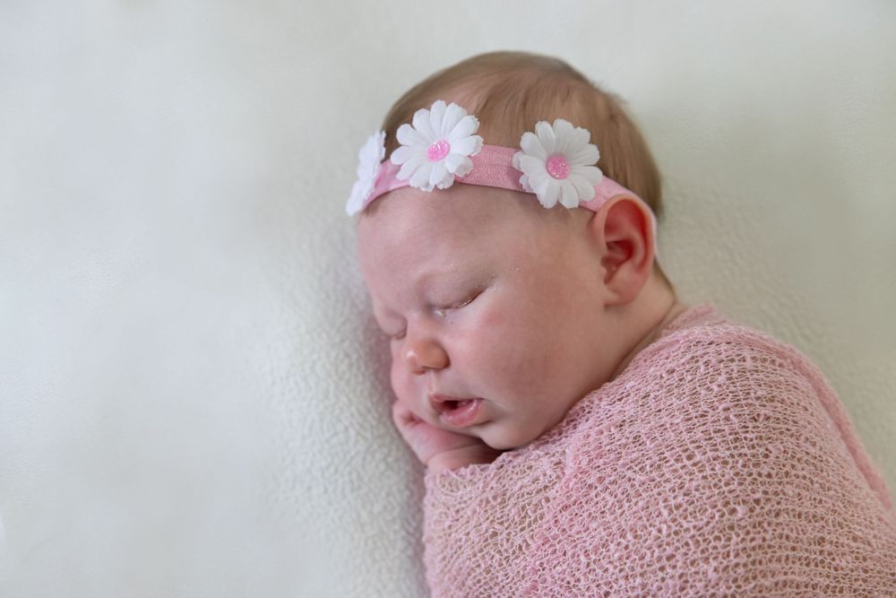 Newborn photography of sleeping baby with flower crown