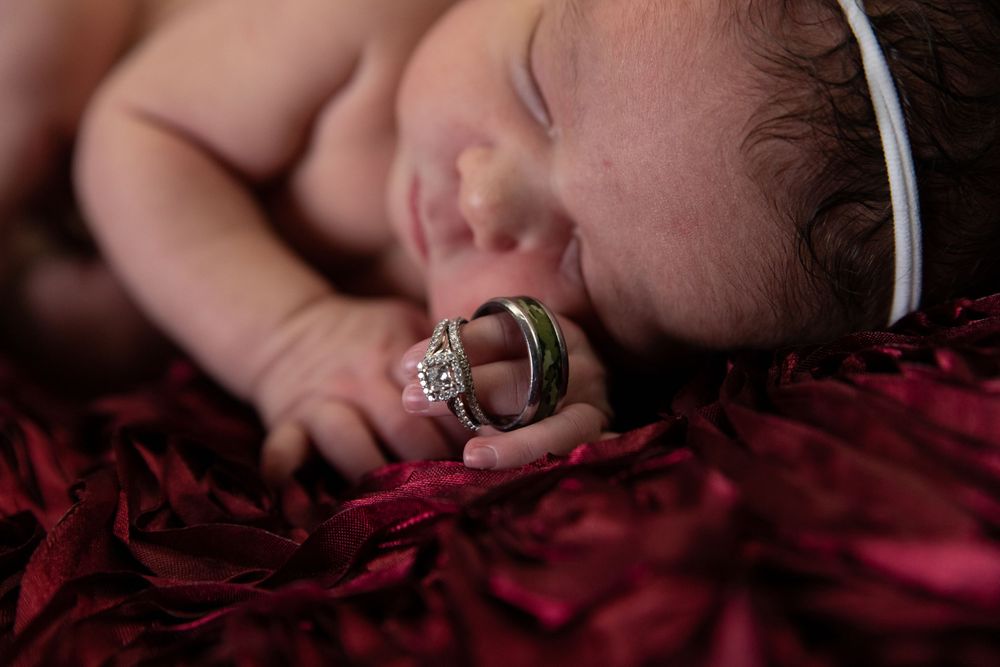 Newborn photography of sleeping baby with rings