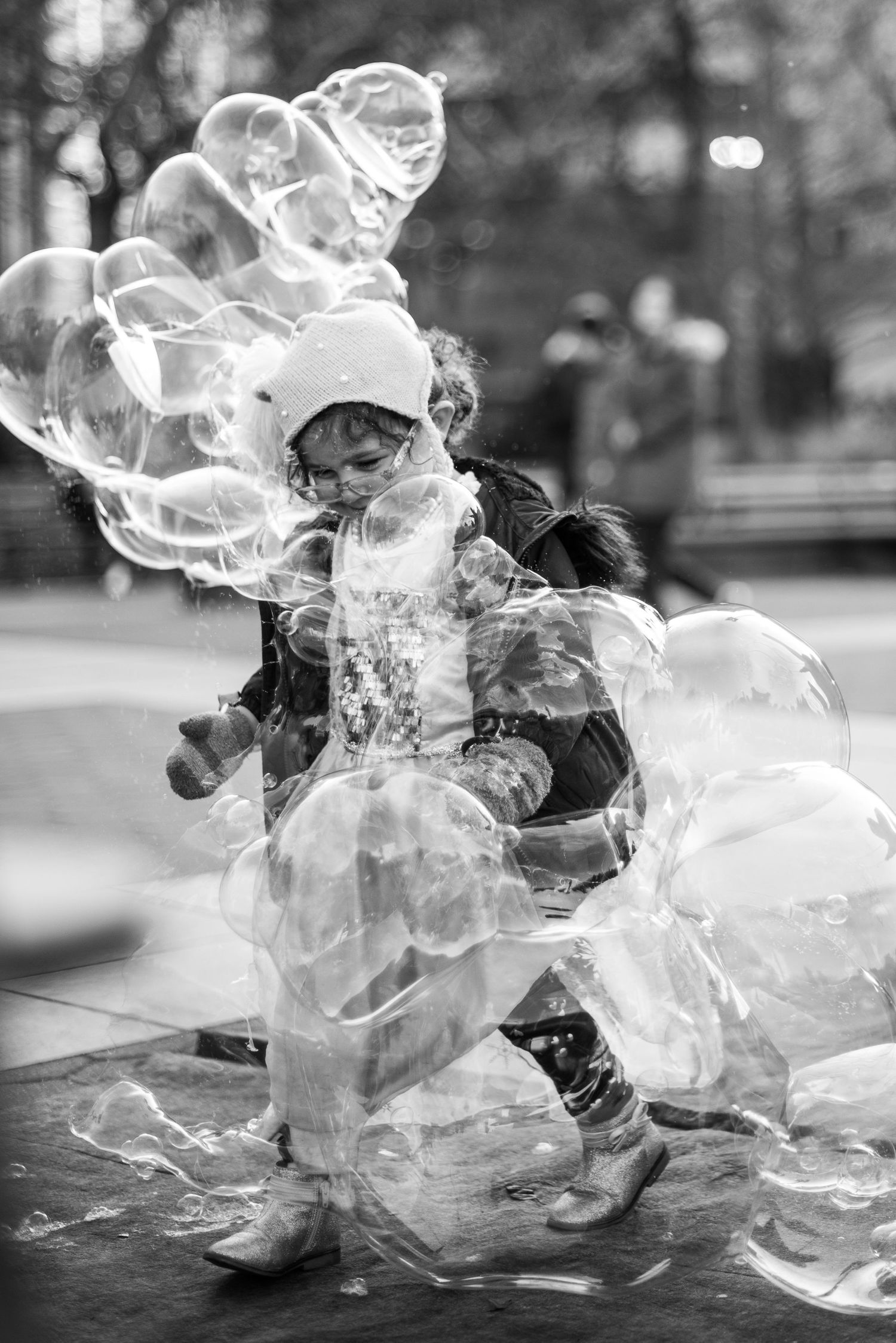 Little girl playing with bubbles in Washington Square Park, NYC