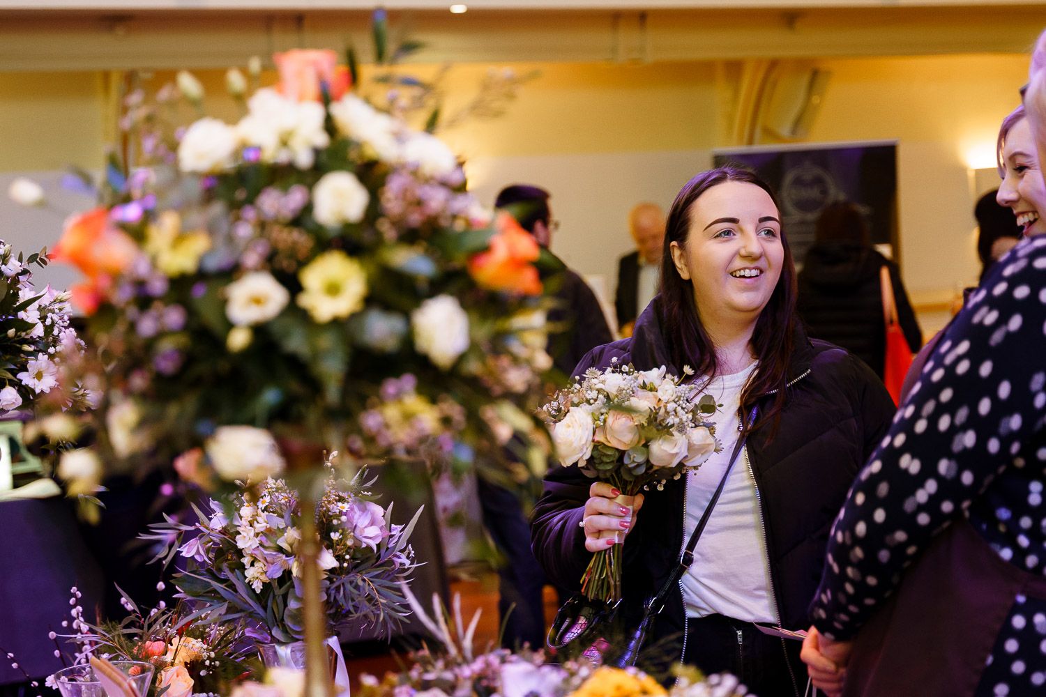 A bride-to-be chats with a florist at a wedding fair in Winchester.