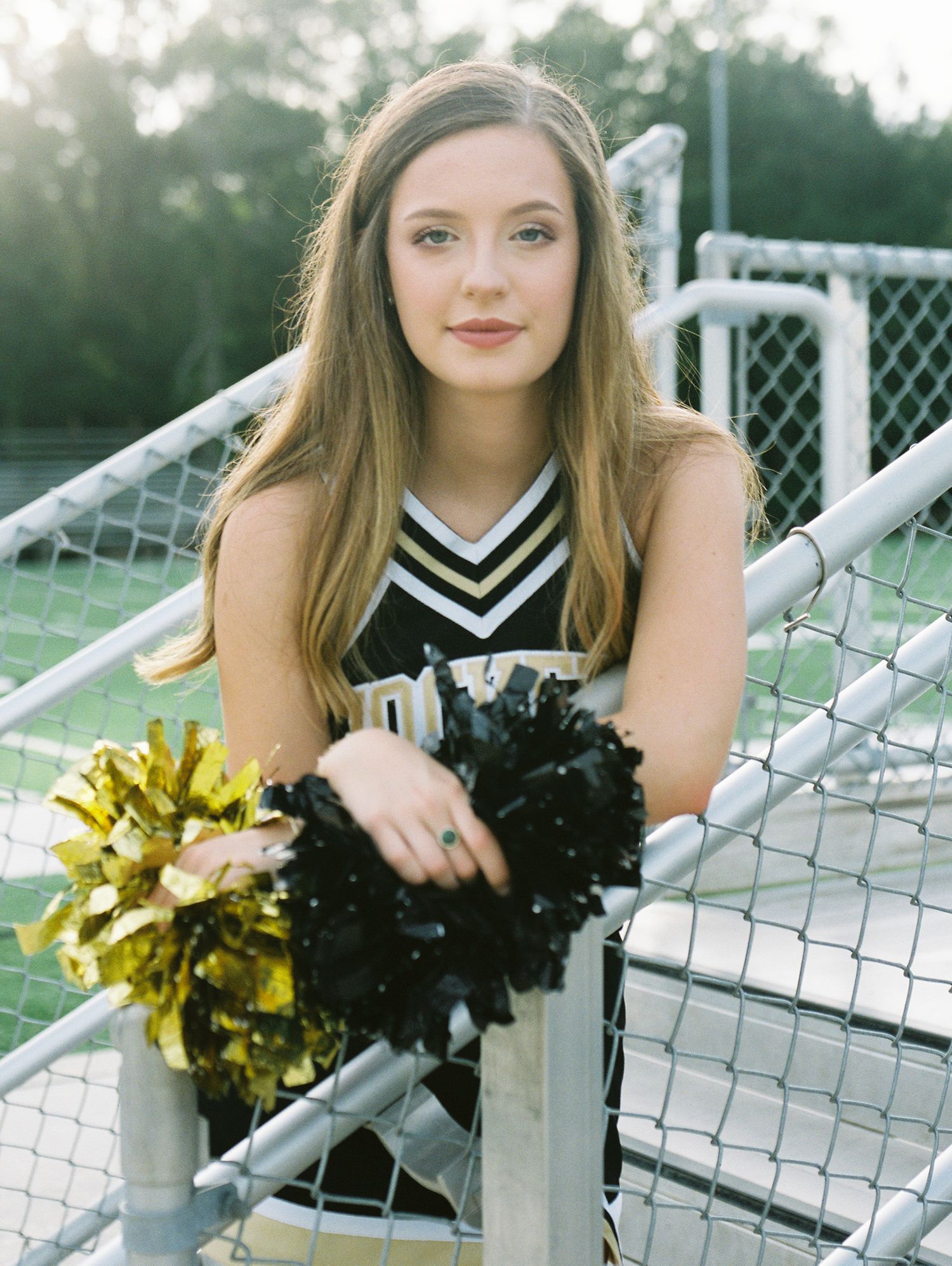 Louisiana senior portrait photography of Oak Forest Academy cheerleader in the football stadium