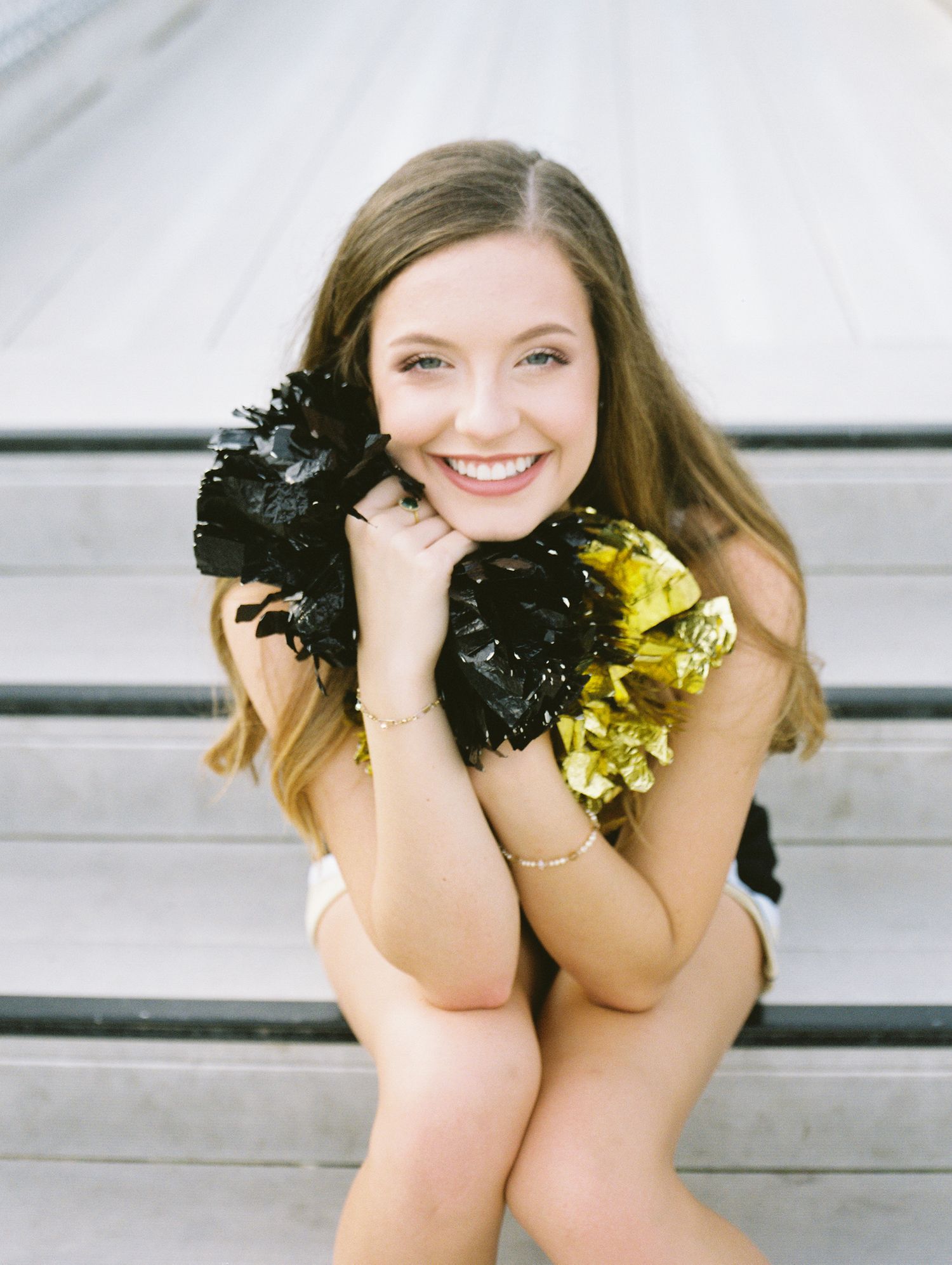 Louisiana senior portrait photography of Oak Forest Academy cheerleader in the football stadium