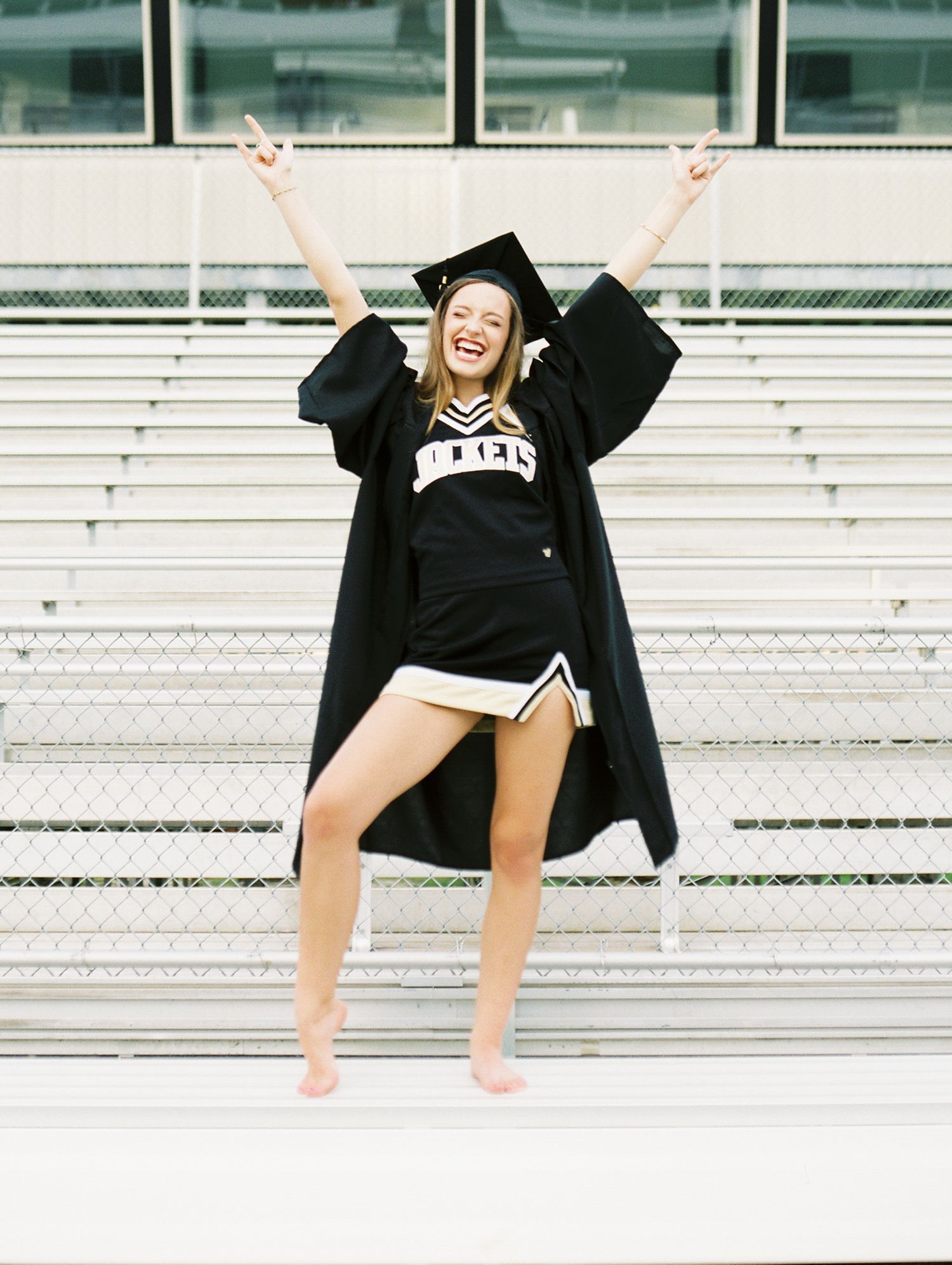 Louisiana senior portrait photography of Oak Forest Academy cheerleader in the football stadium