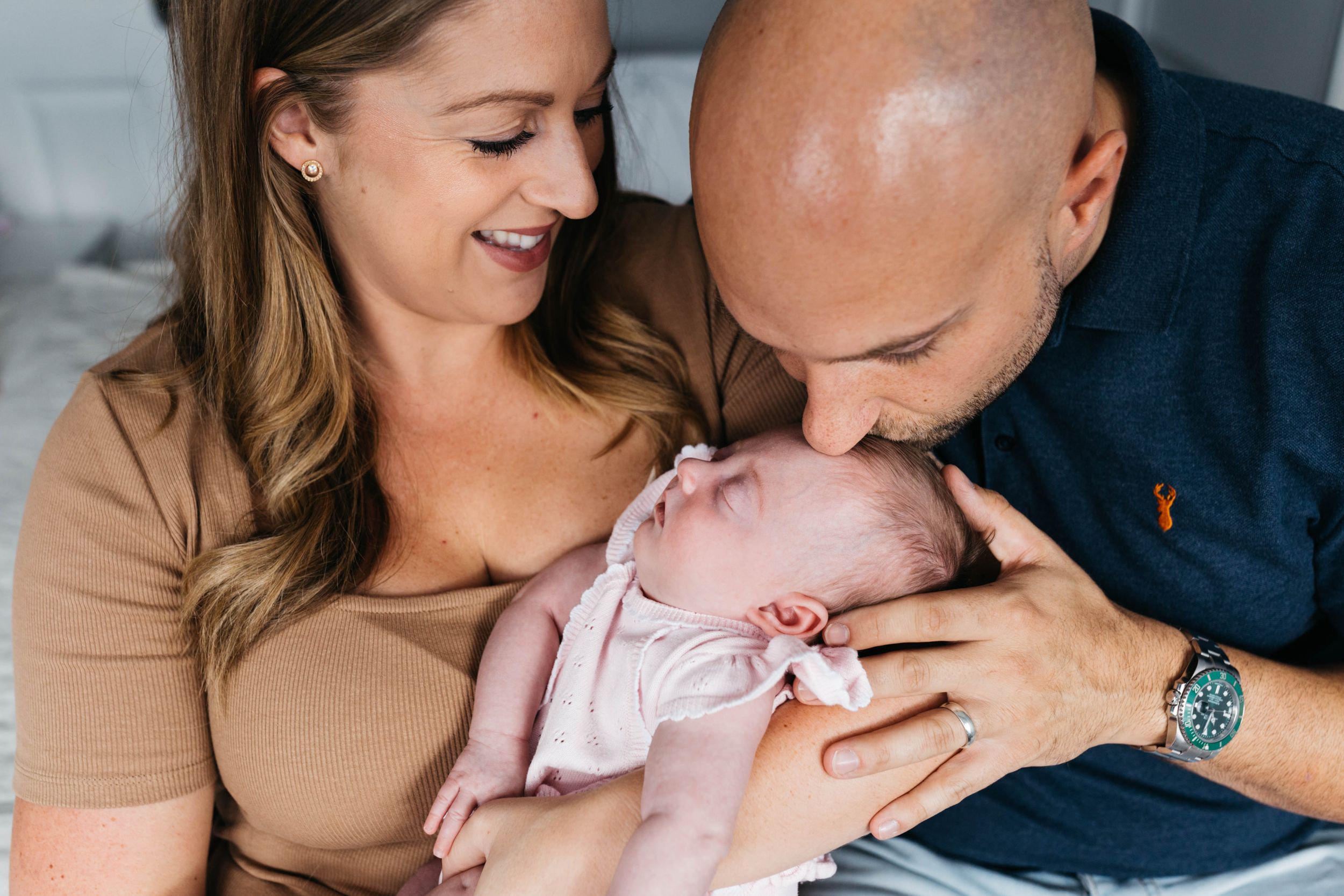 dad kissing baby daughter head East London