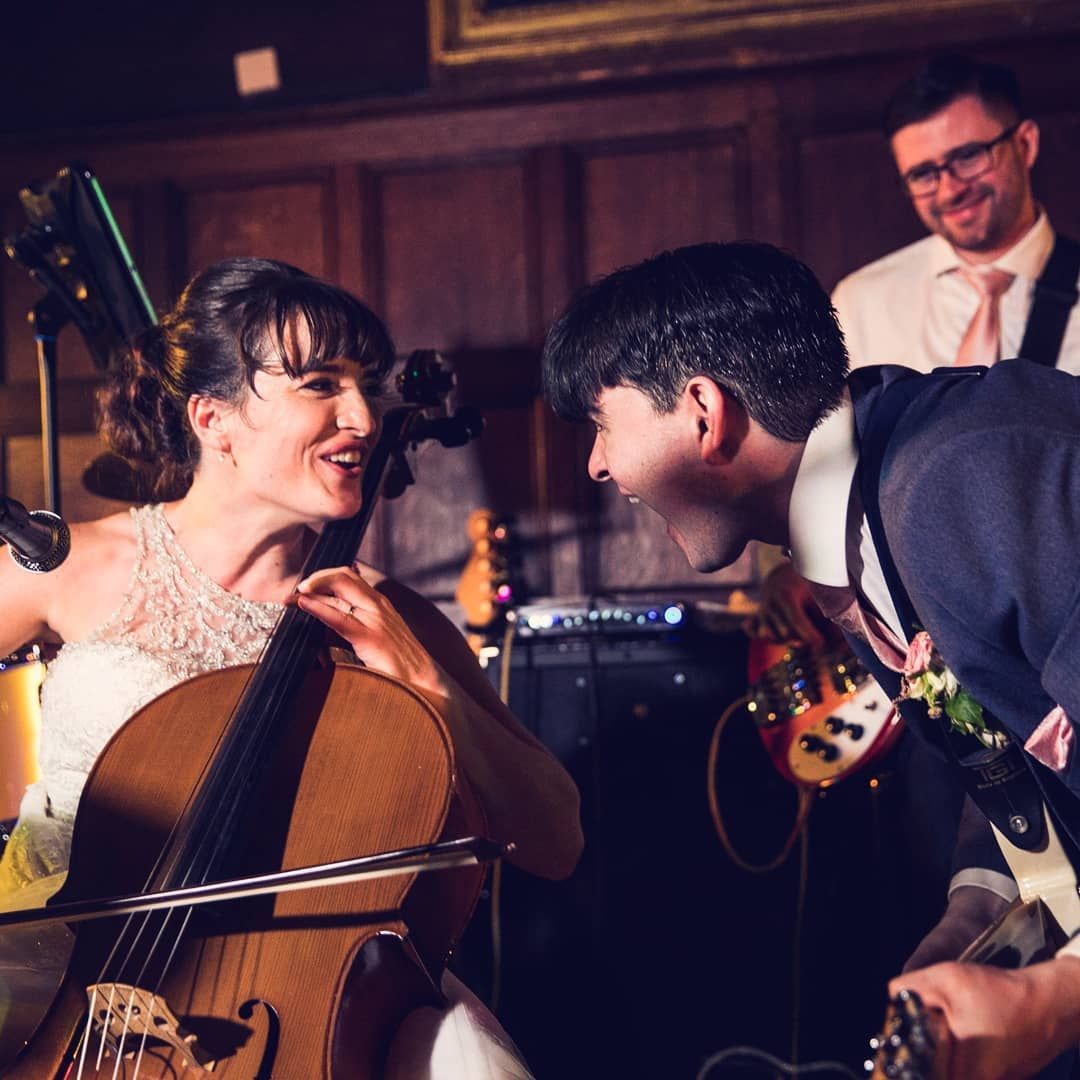 A rock and roll bride and groom play in a band together singing at each other