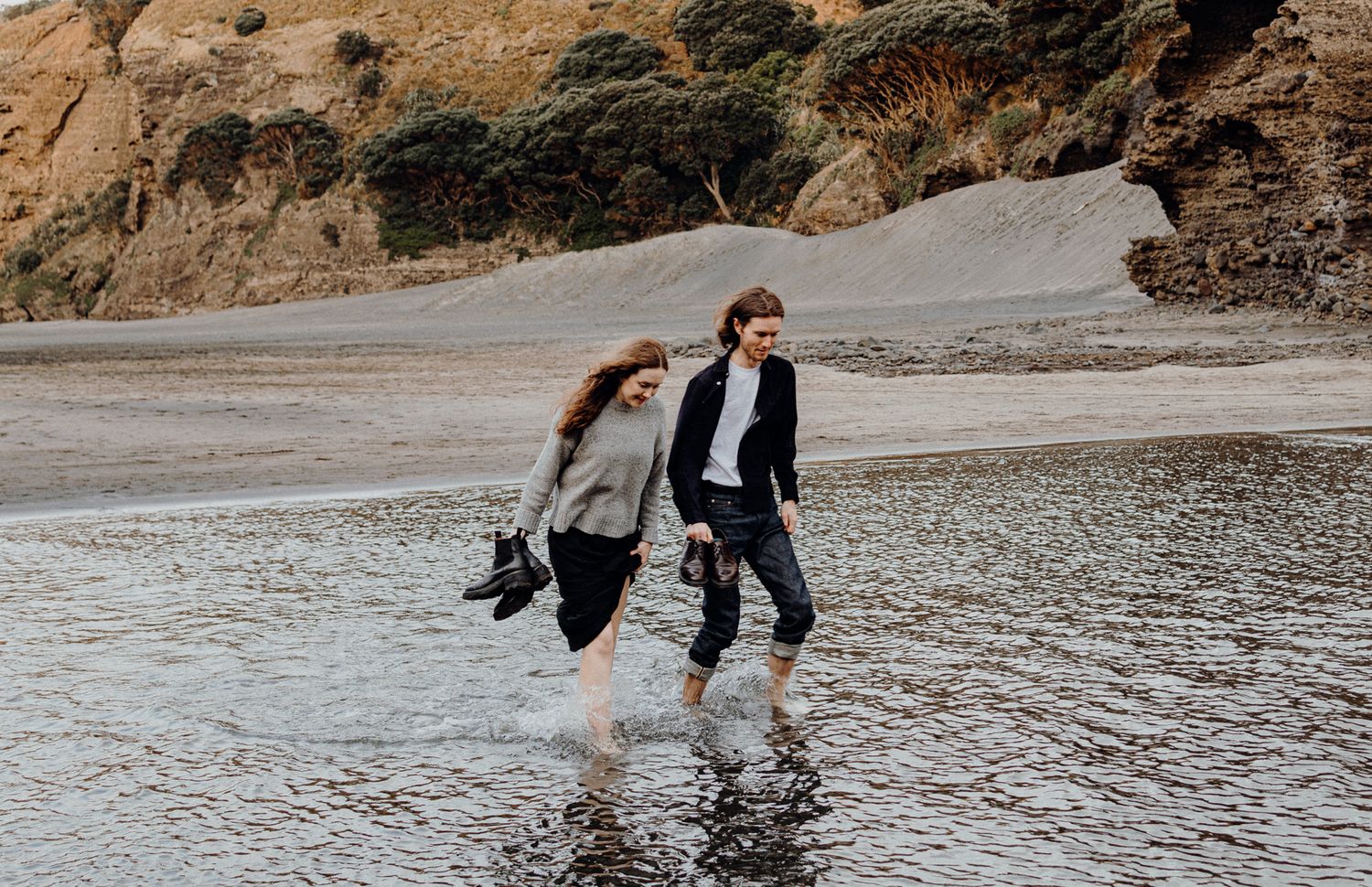 A couple during their engagement shoot in Piha with Apertured Media-Auckland Wedding and Elopement Photographer