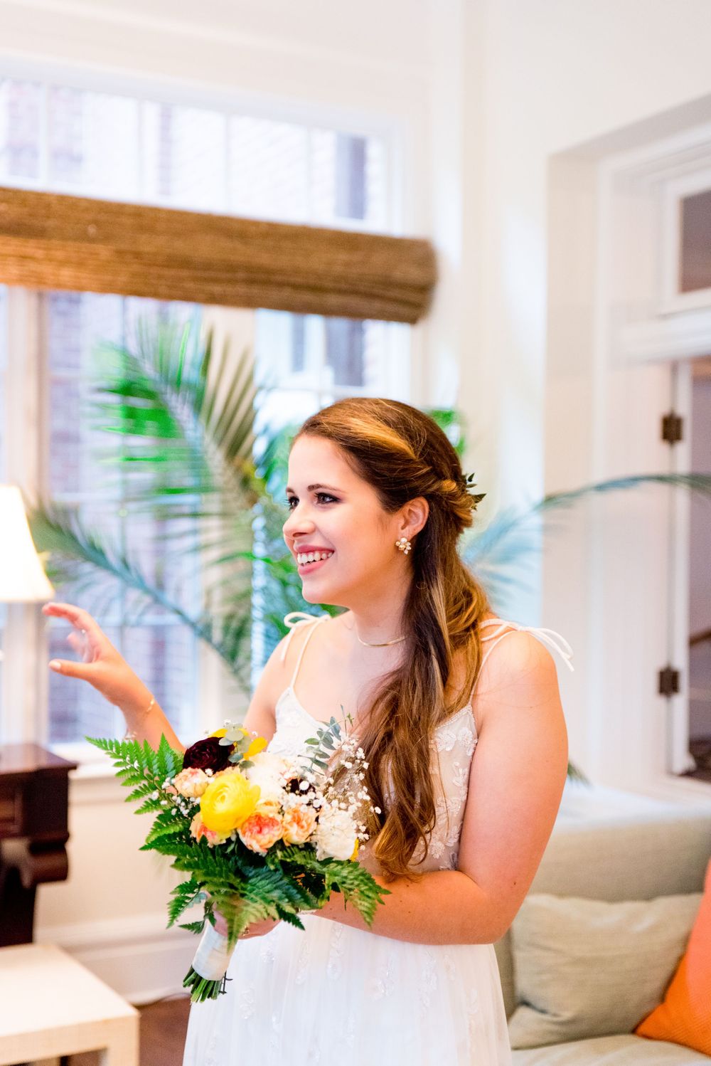bride smiles at her groom on their wedding day and holds her flowers at the Woman's Club of Evanston brunch wedding