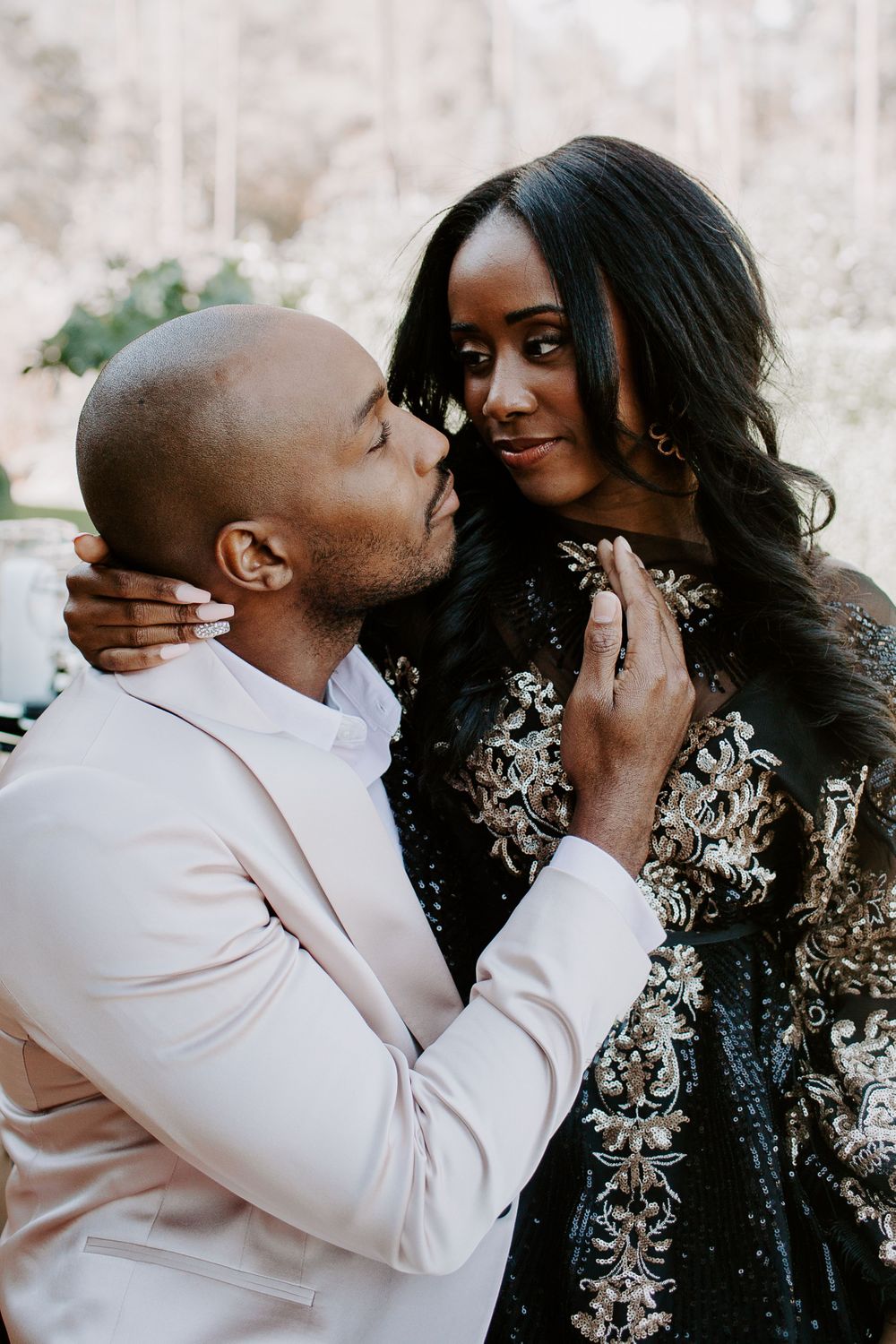 man bringing his wife in for a kiss during their winter elopement