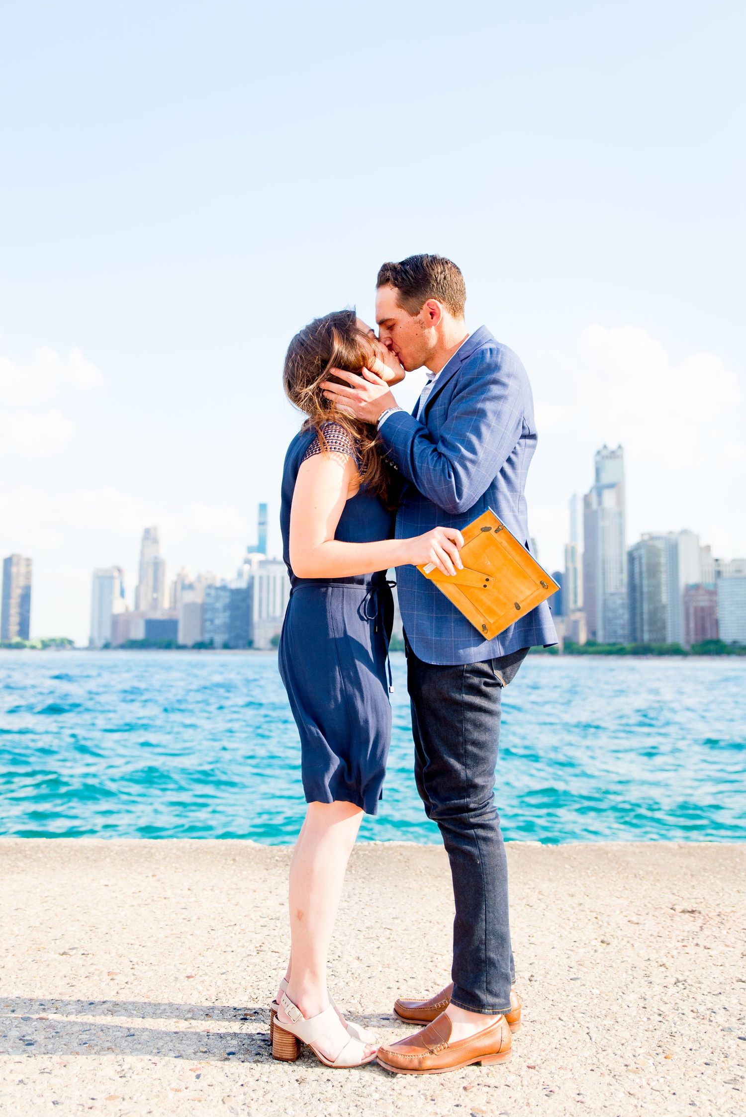 man kissing fiance at North Avenue Beach proposal in the summer