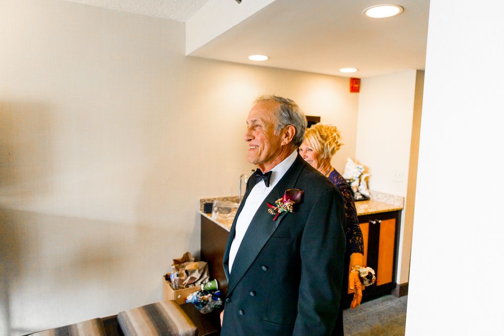 dad in tuxedo smiles during first look at his daughter on chicago wedding day