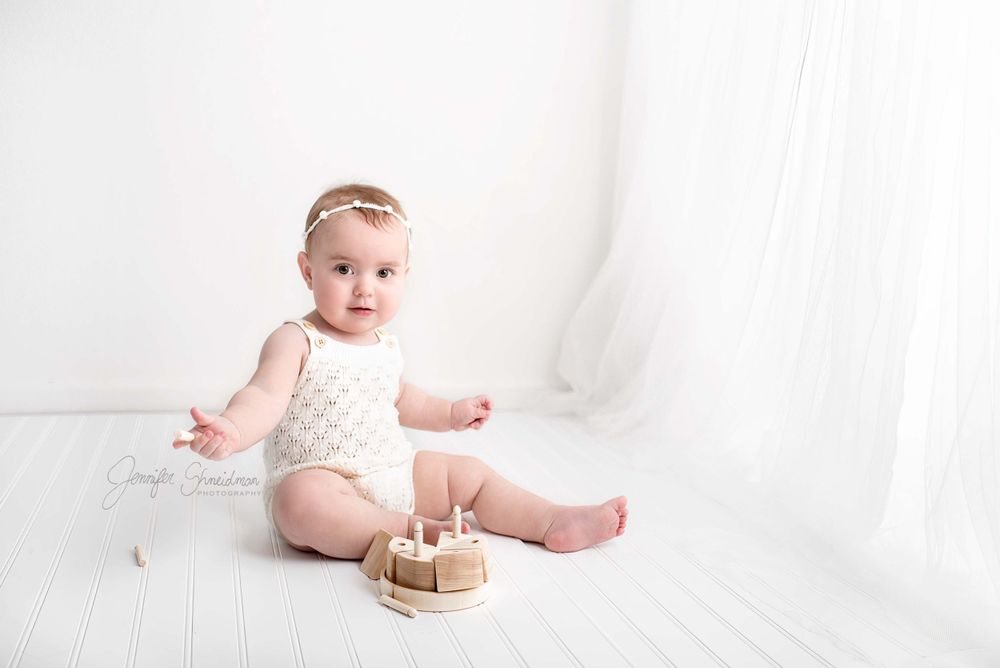 Baby Milena looks adorable in an all white room set up for her first birthday photos,