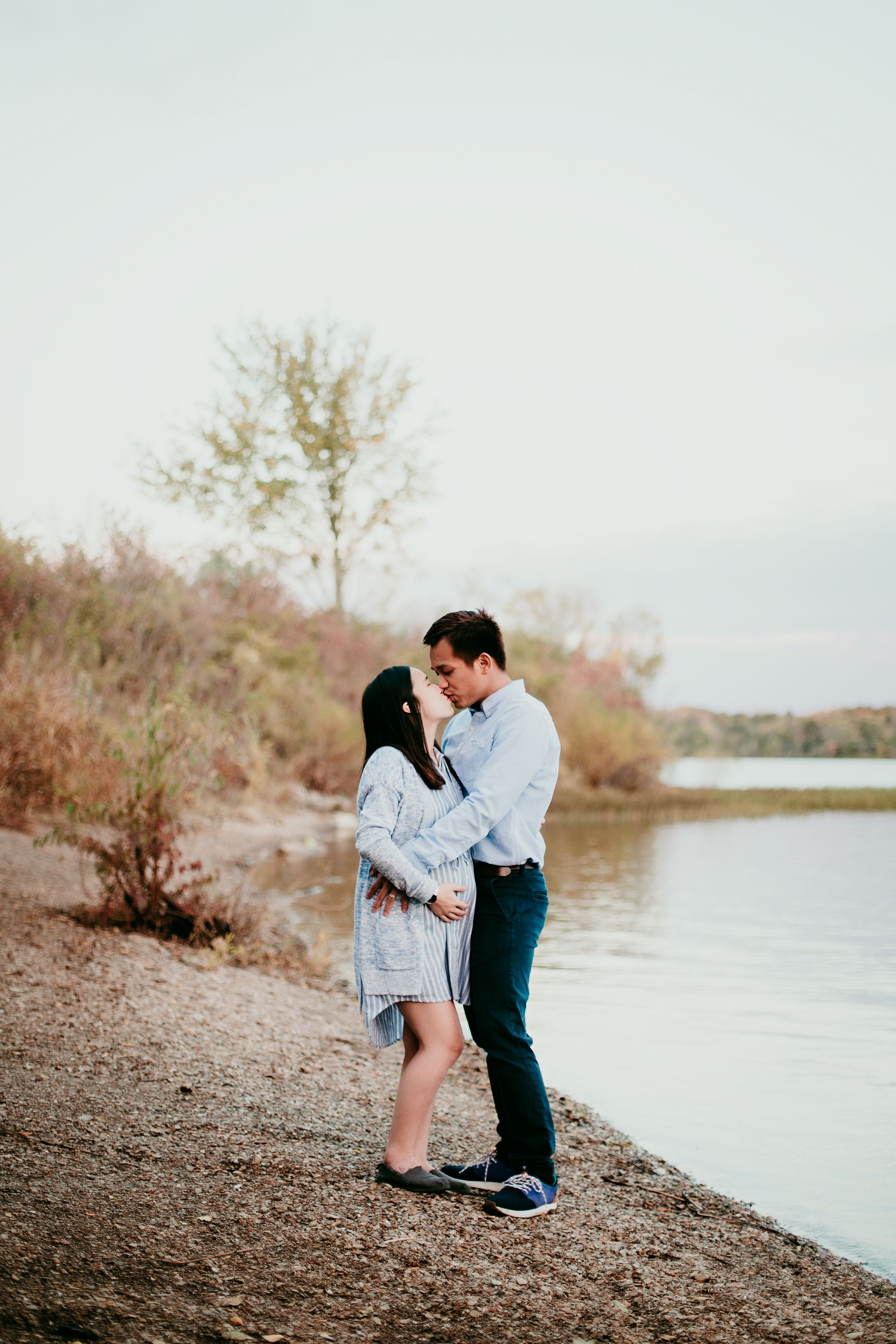 couple kissing by waters edge