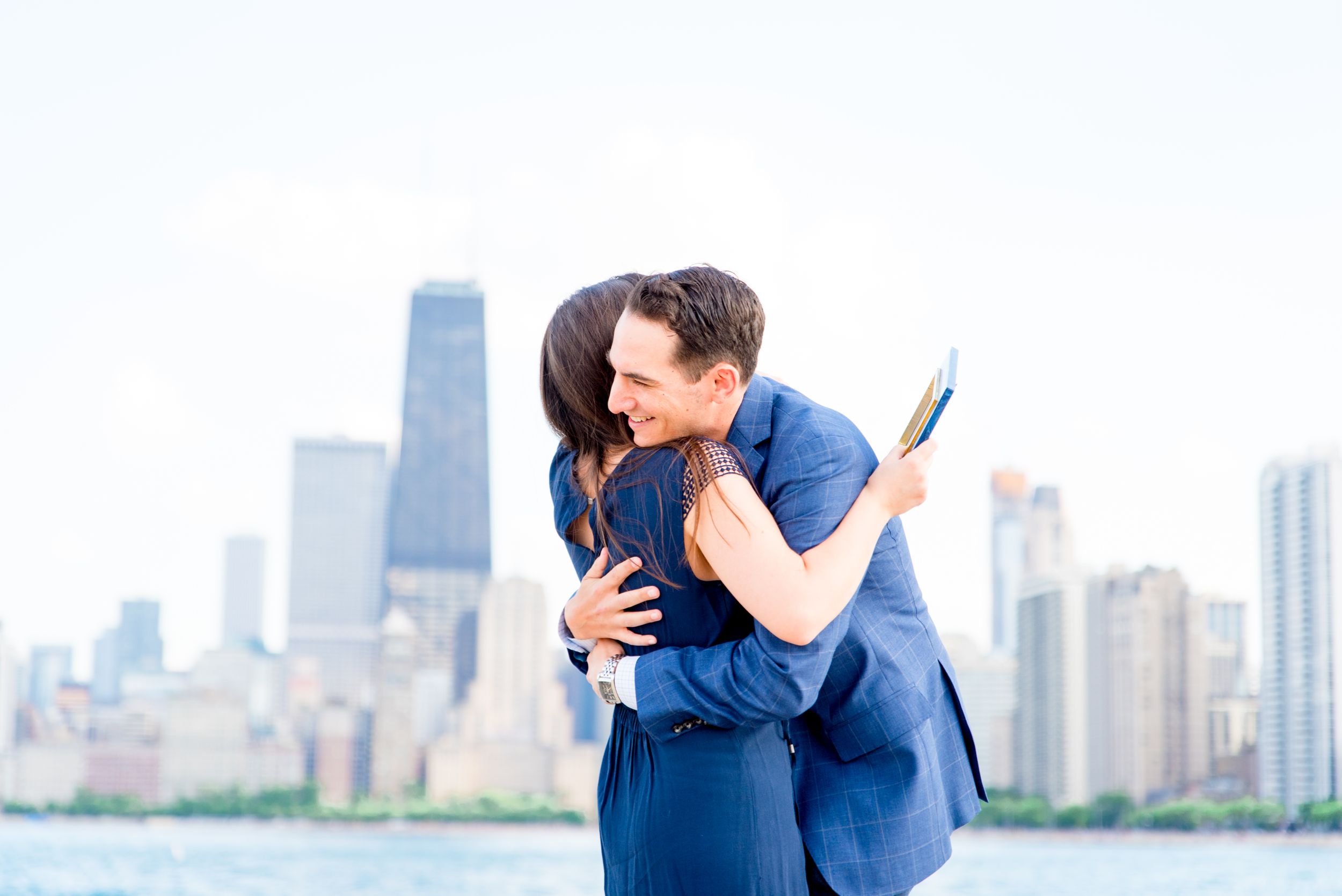 man hugging fiance at North Avenue Beach proposal in the summer