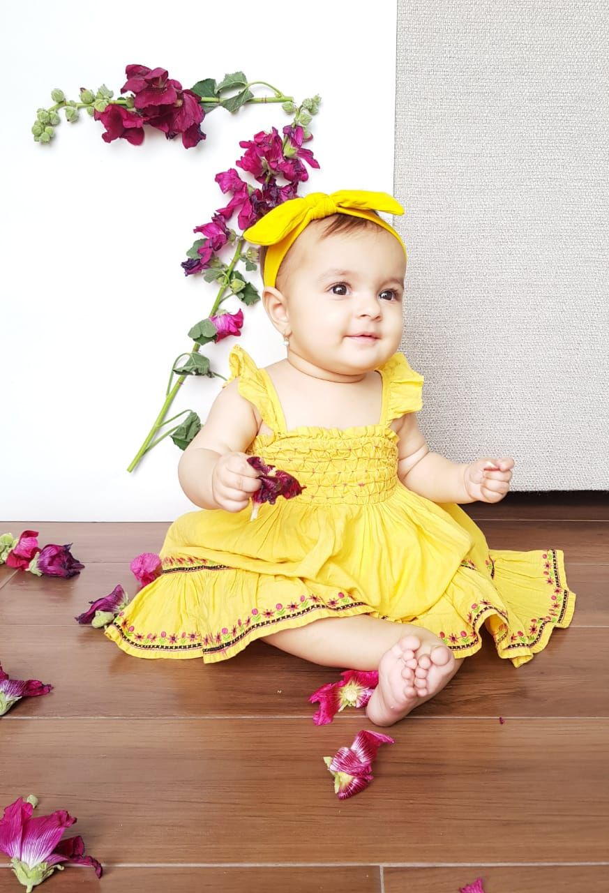 cute baby girl in yellow dress
