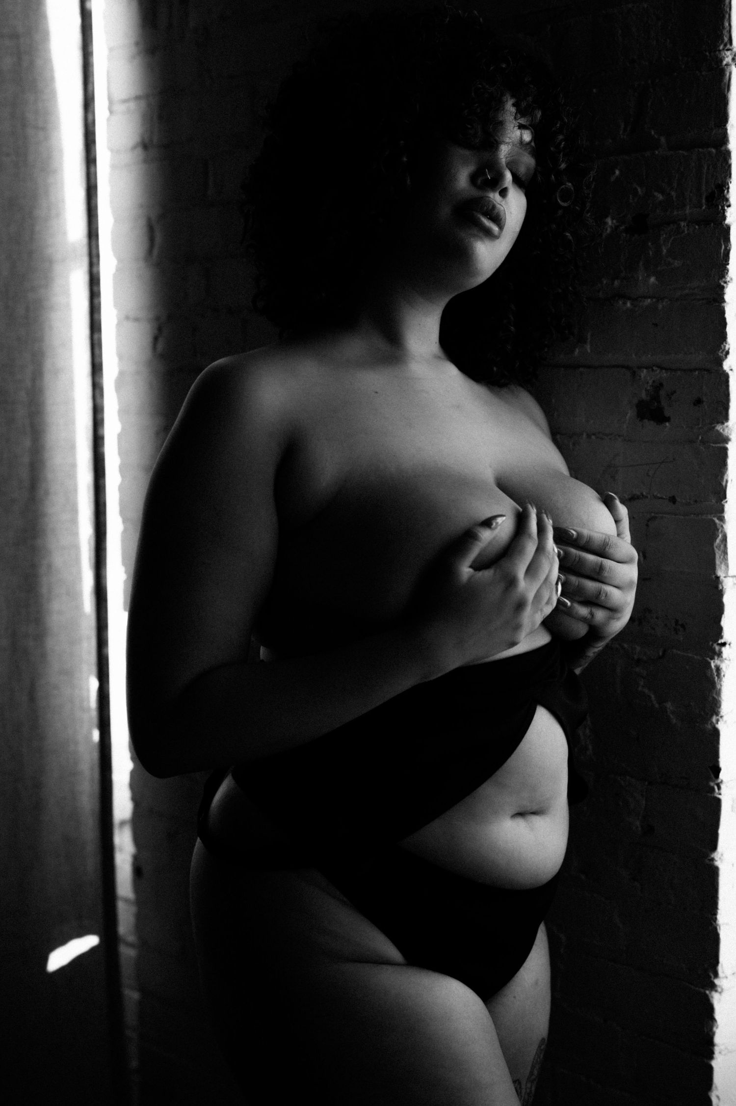 Black and white intimate portrait in dramatic lighting.