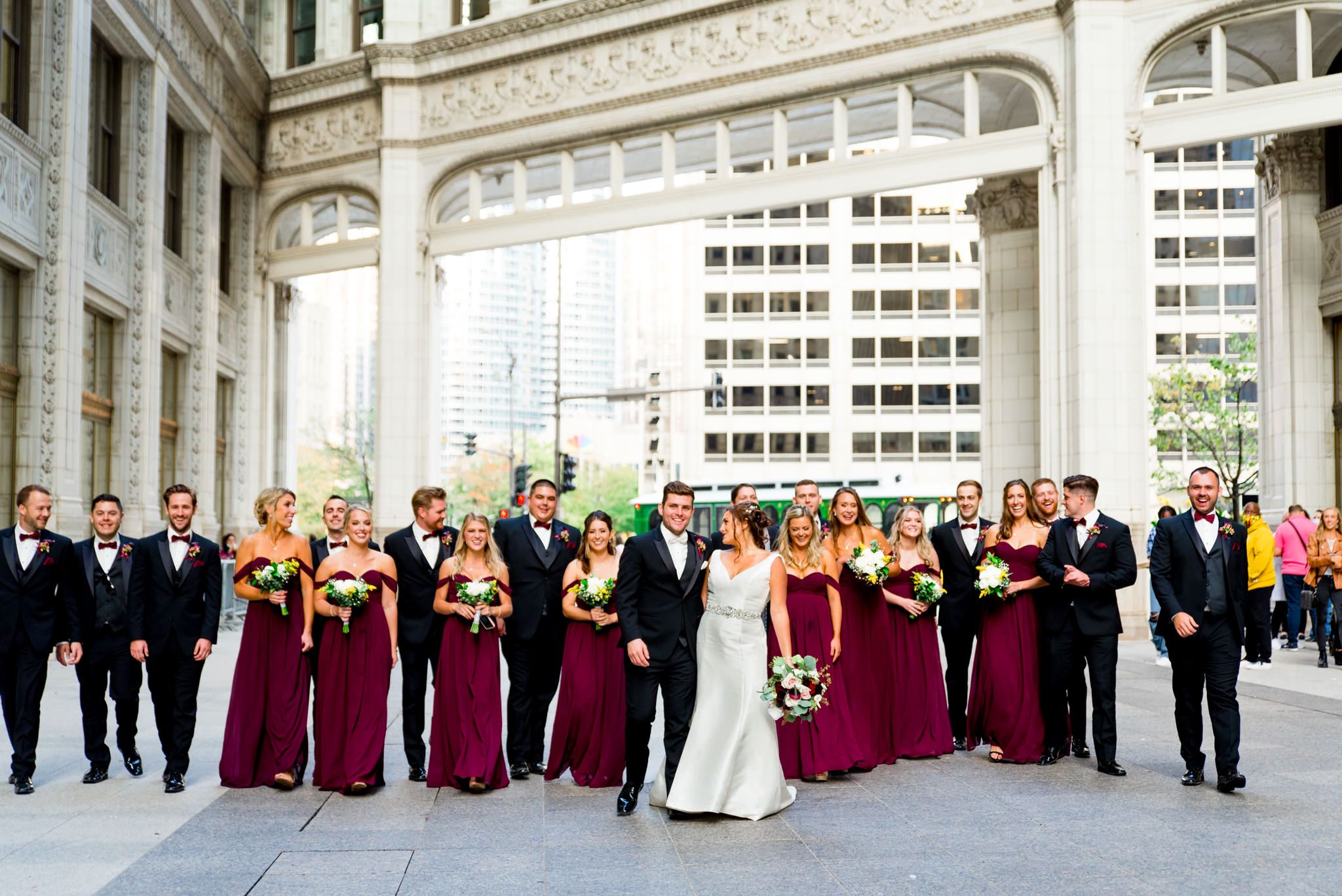 red and black wedding party walk through chicago during october wedding