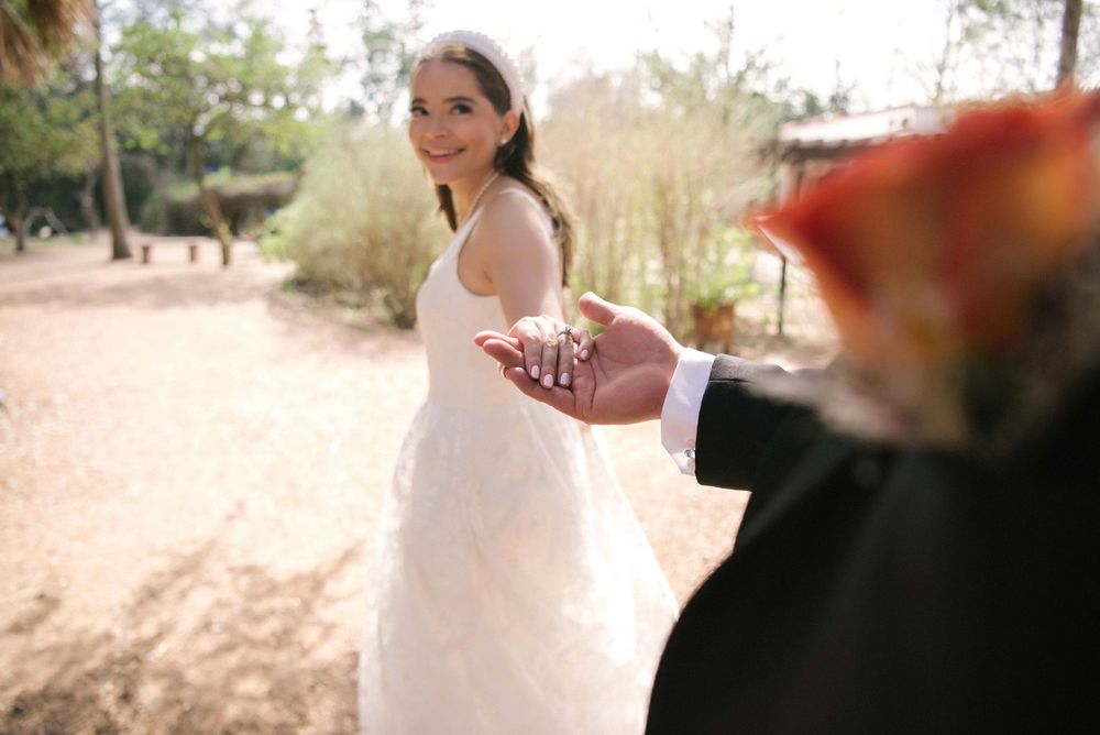 Bride and groom holding hands walking along together. McAllen TX photographer