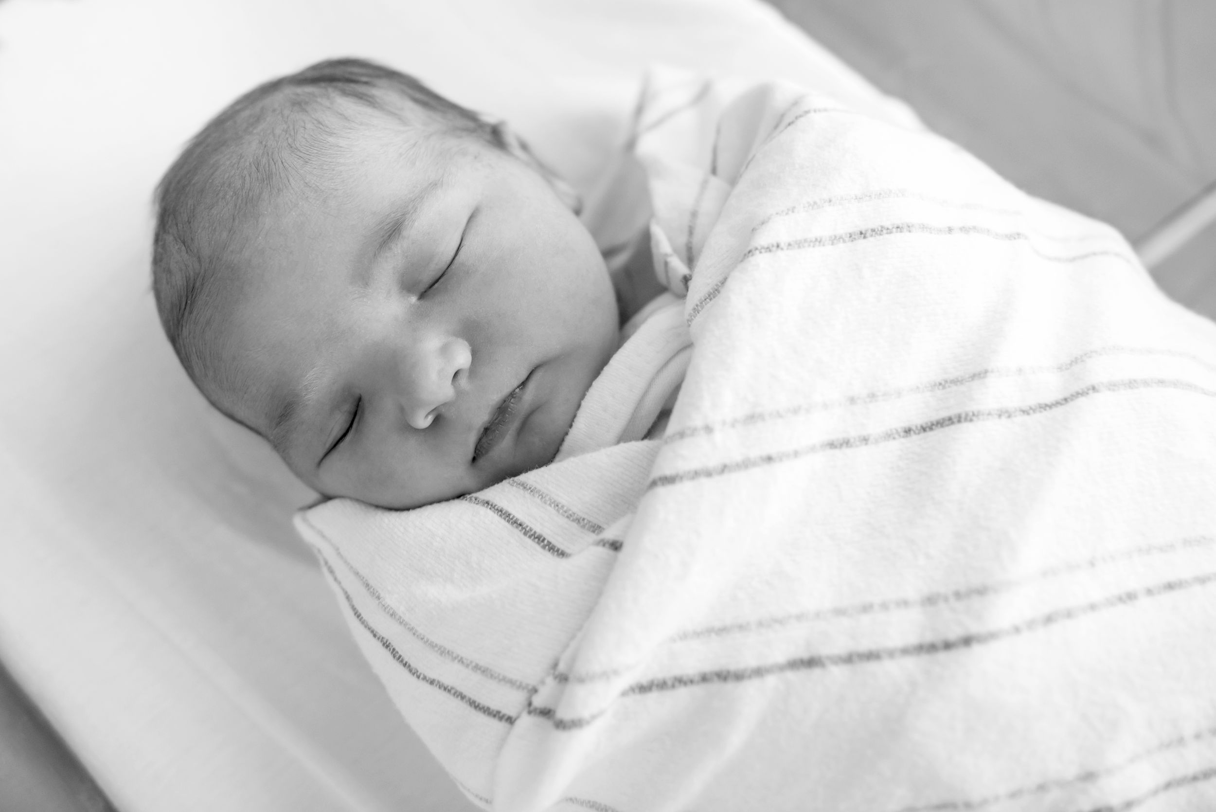 First moments with newborn baby captured in a Fresh 48 session by Heidi Harting Photography in Plymouth, MA