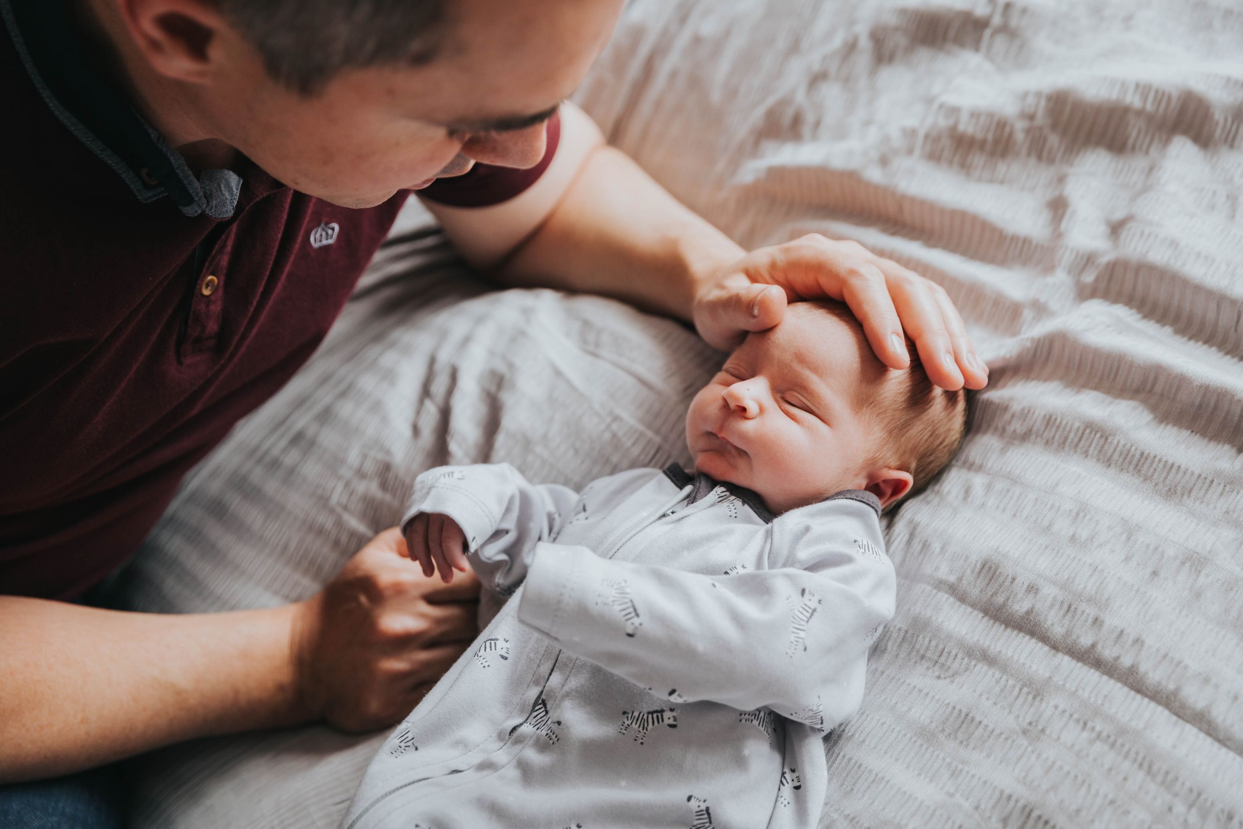 dad stroking baby boy head