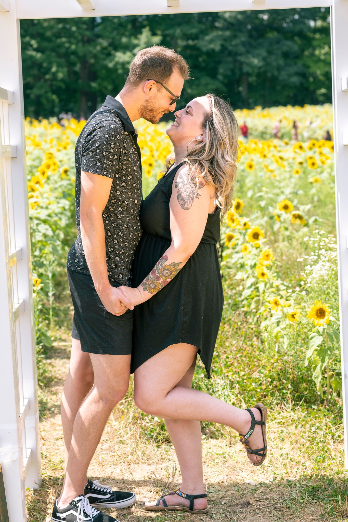 A couple looking at each other during Sunflower Mini-Sessions
