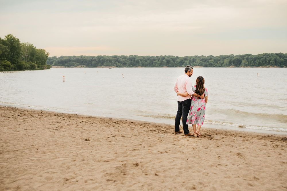 husband and wife watch the sunset over caesar creek lake