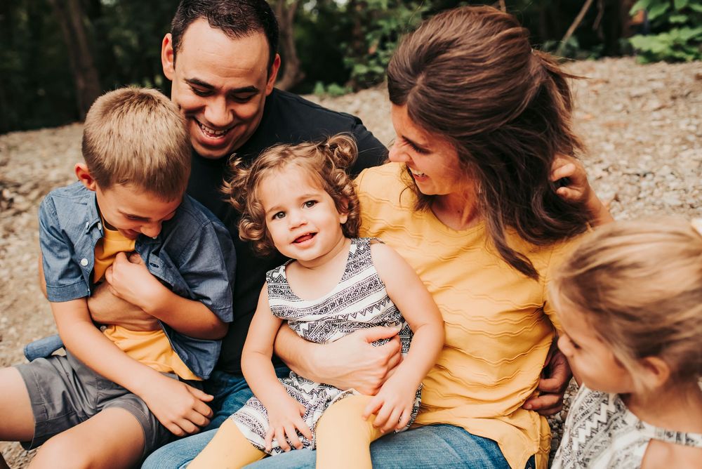 family snuggles together for family photos