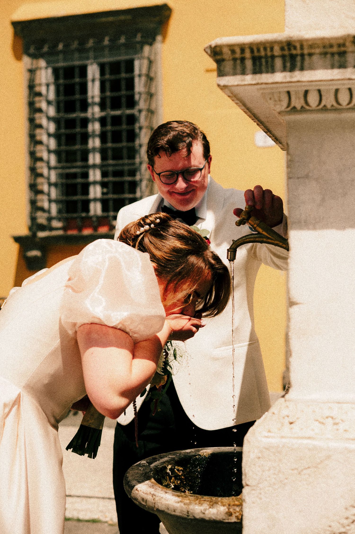 A playful moment at a historic water fountain in Italy.