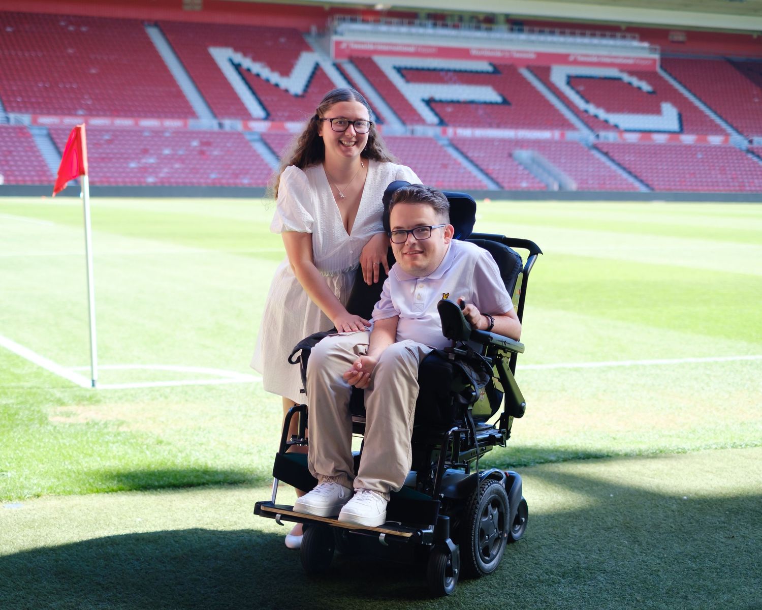 Owen and Lucy stood near the corner flag in the Riverside Stadium, home of Middlesbrough Football Club.