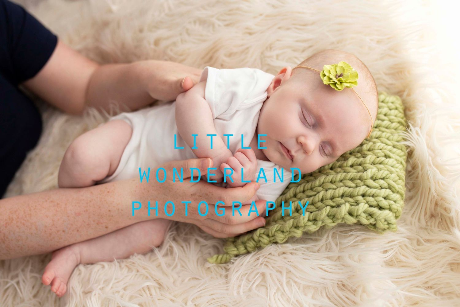 Two month old baby posed in with parents hands by Little Wonderland Photography, Widnes, Cheshire