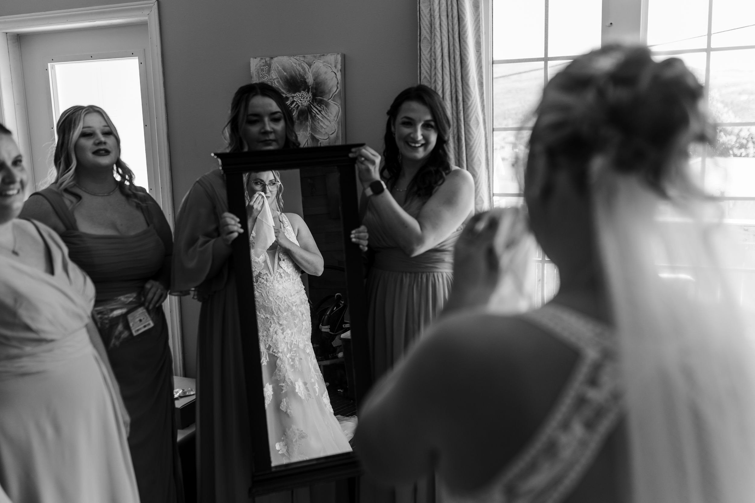 Black and white candid photos of guests mingling at a wedding reception are displayed in a collage.