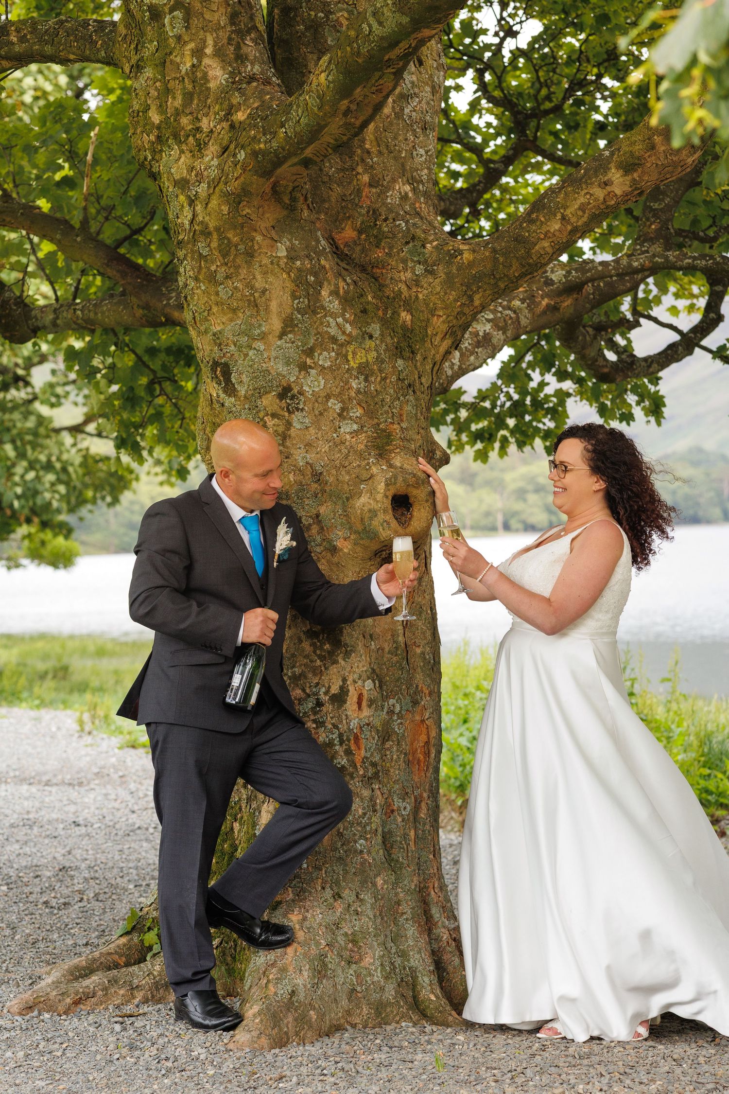 Playful wedding photo sequence showing couple interacting and laughing by a large tree trunk.