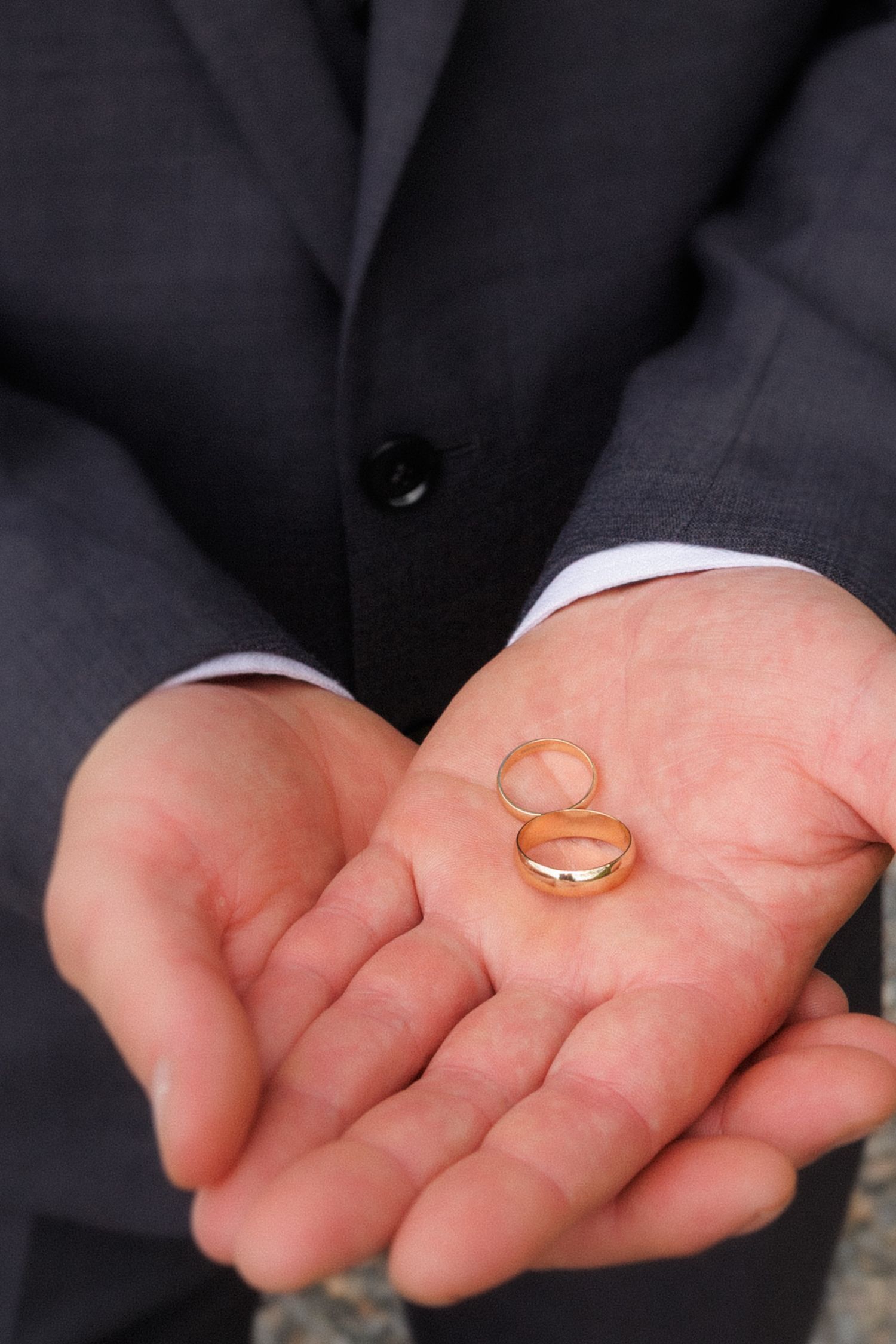 A gold wedding ring rolls across an outstretched palm in a sequence of motion capture photos.