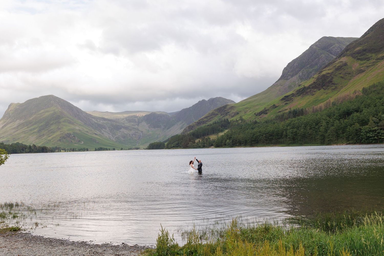 Scenic panoramic view of misty mountains surrounding a tranquil lake in the English countryside.
