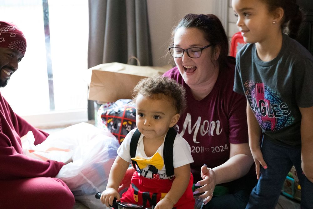 A joyful moment shared indoors with several people playing with toys together.
