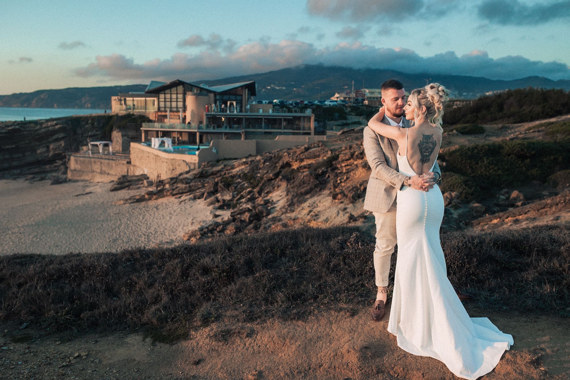 Intimate embrace between bride and groom at Arriba by the sea wedding venue, captured in Portugal by a destination wedding photographer