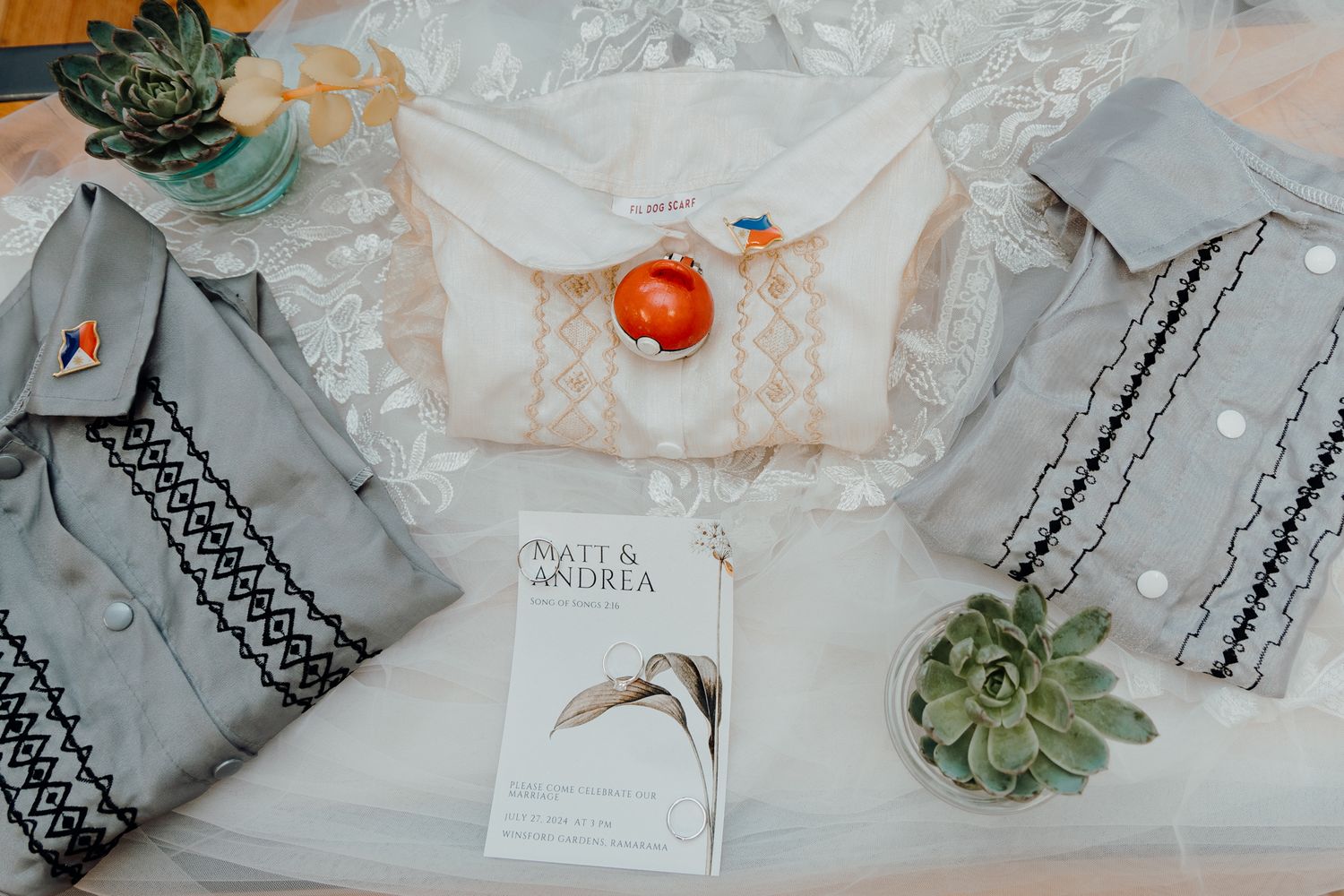 Wedding attire and decor featuring traditional Barongs, succulents and white fabric.