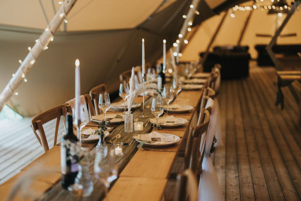Wedding reception tables with elegant white linens and candlesticks at Scrivelsby Walled Garden.