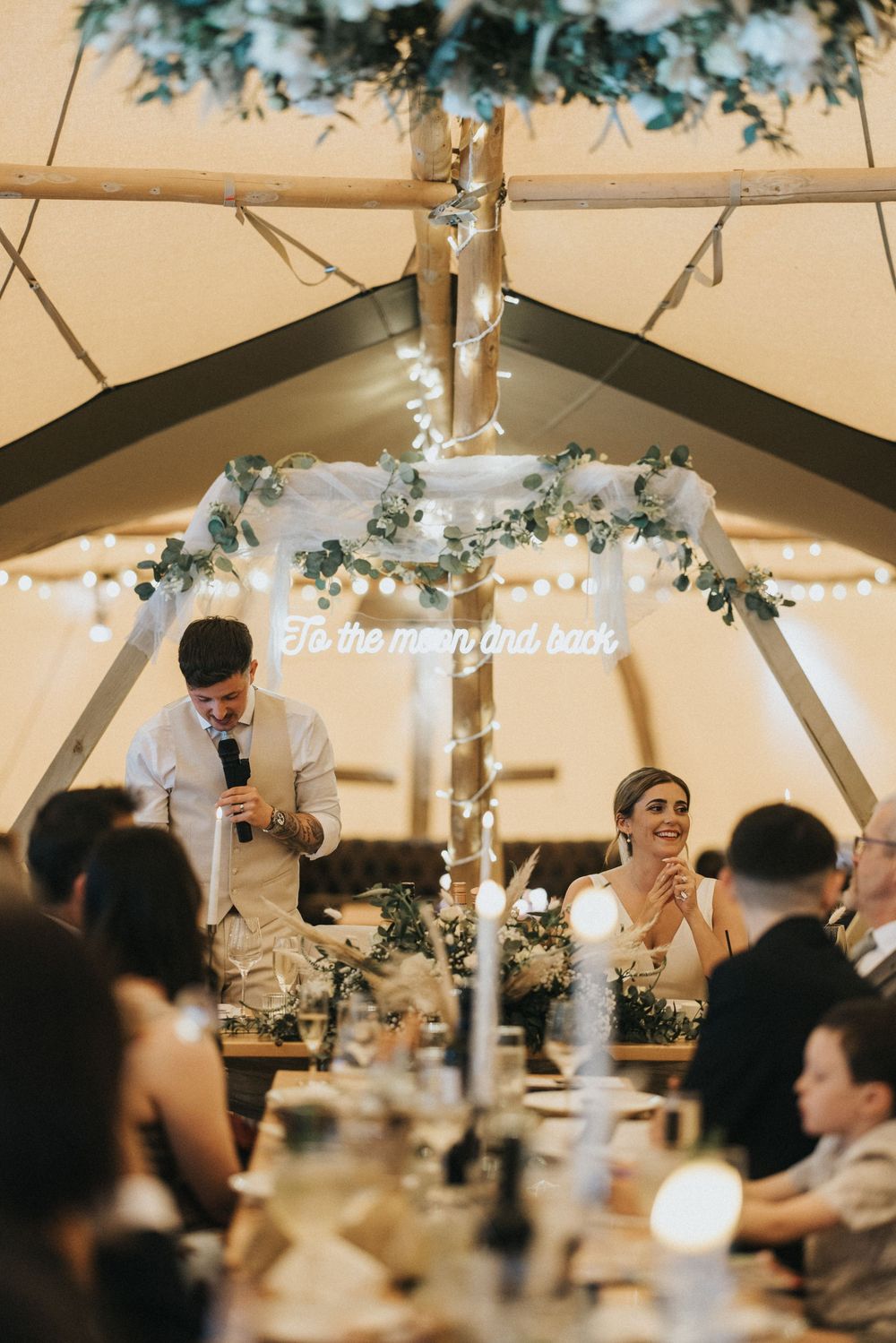 Romantic wedding reception under a tent with twinkling lights and floral decor creating an elegant atmosphere at Scrivelsby Walled Garden.