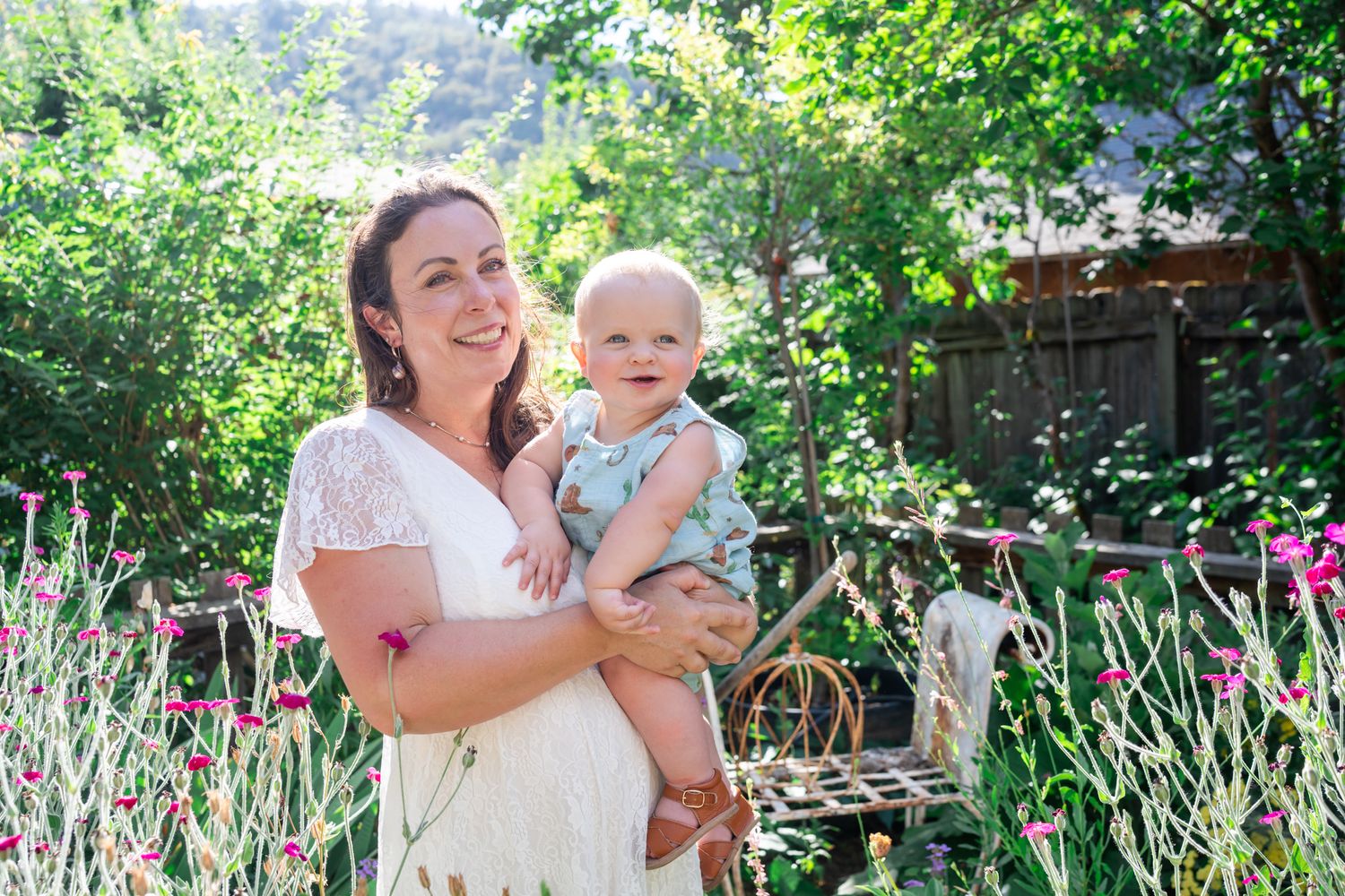 Mom holding baby boy in the garden