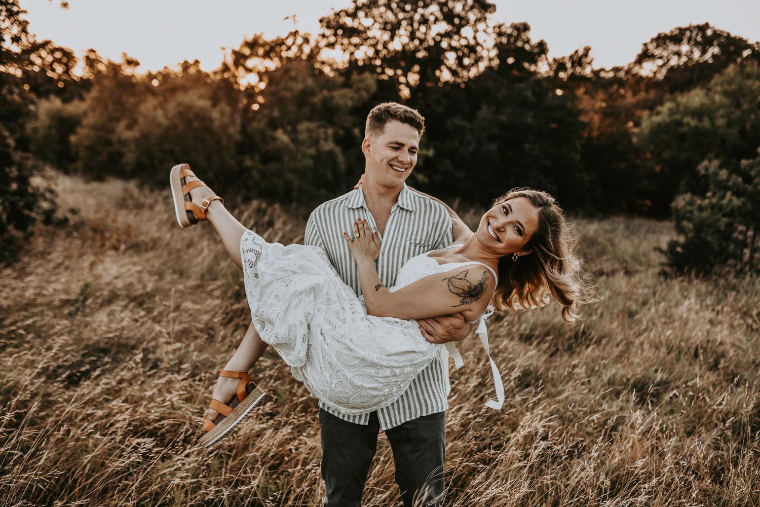 Romantic dip in the middle of golden grass at sunset
