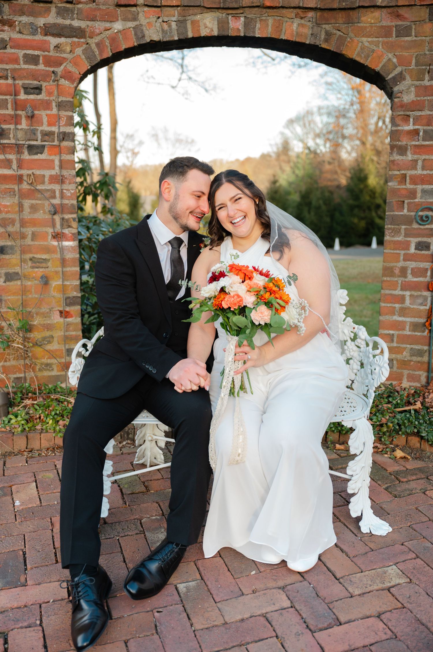 Newlyweds share intimate moments on brick patio during outdoor wedding photoshoot at Keeler Tavern in Ridgefield, CT.